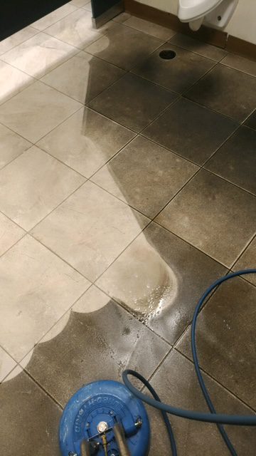 Tile floor half-cleaned with equipment