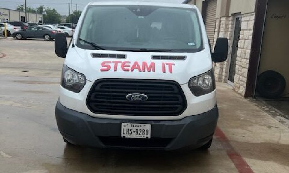 A white van with the words " steam it ".