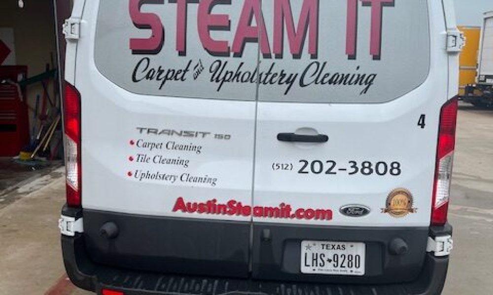 A van with the words " steam it carpet & upholstery cleaning ".